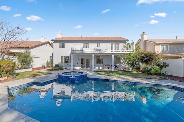 view of pool with an in ground hot tub and a patio area