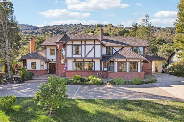 tudor home with a front yard