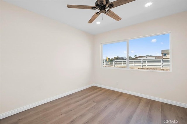 unfurnished room with ceiling fan and light hardwood / wood-style flooring