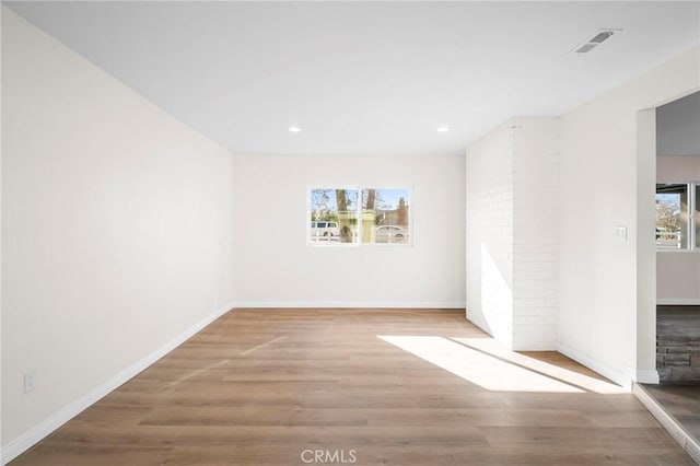 empty room with hardwood / wood-style floors