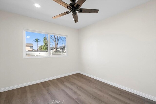 empty room featuring ceiling fan and hardwood / wood-style flooring