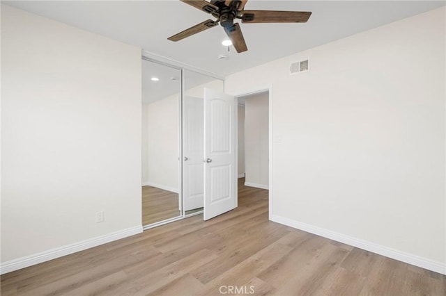 unfurnished bedroom with ceiling fan, a closet, and light hardwood / wood-style flooring