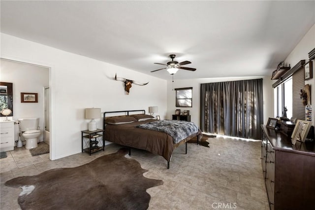 bedroom featuring ceiling fan and ensuite bathroom