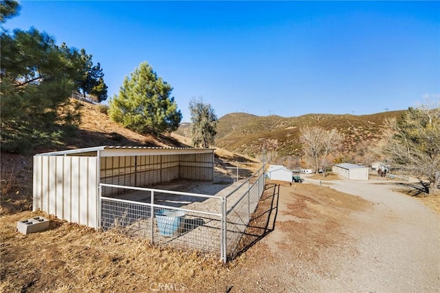 view of horse barn featuring a mountain view