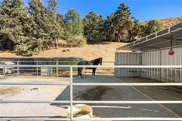 view of stable featuring a rural view