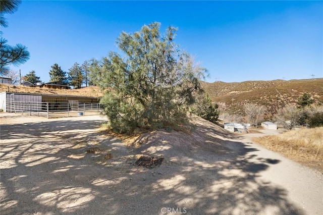 exterior space featuring a mountain view and an outdoor structure