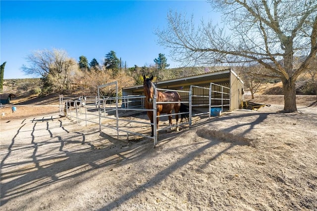 view of horse barn with a rural view