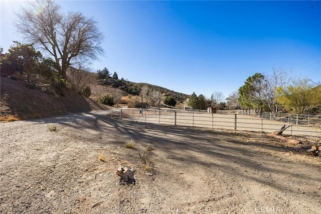 view of yard with a rural view