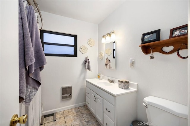 bathroom featuring toilet, tile patterned flooring, and vanity