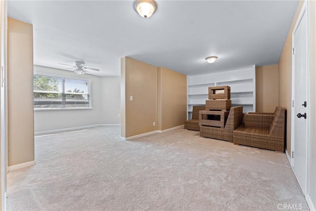 living room featuring ceiling fan and light colored carpet