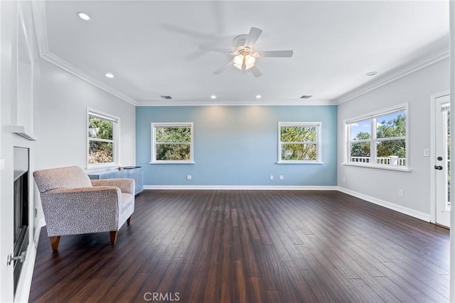 sitting room with a wealth of natural light, dark hardwood / wood-style flooring, and crown molding