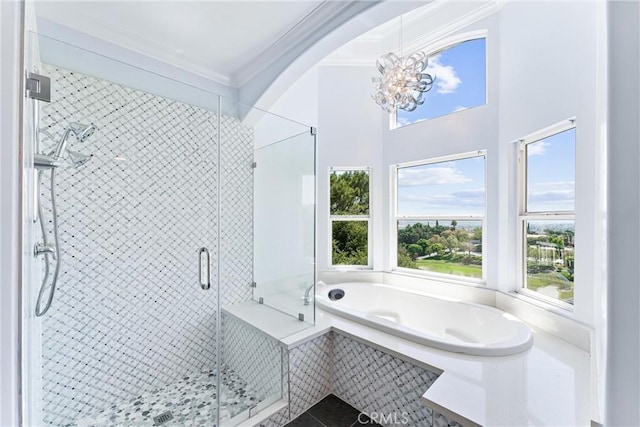 bathroom with ornamental molding, separate shower and tub, and a notable chandelier