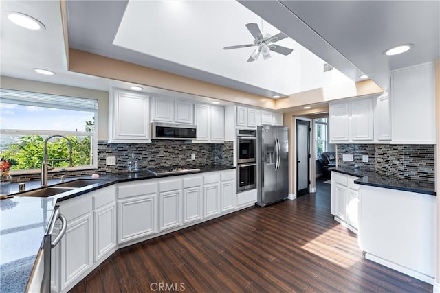 kitchen featuring sink, white cabinetry, stainless steel appliances, and tasteful backsplash