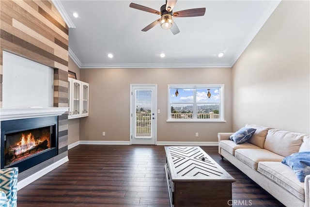 living room featuring ceiling fan, dark wood-type flooring, and crown molding