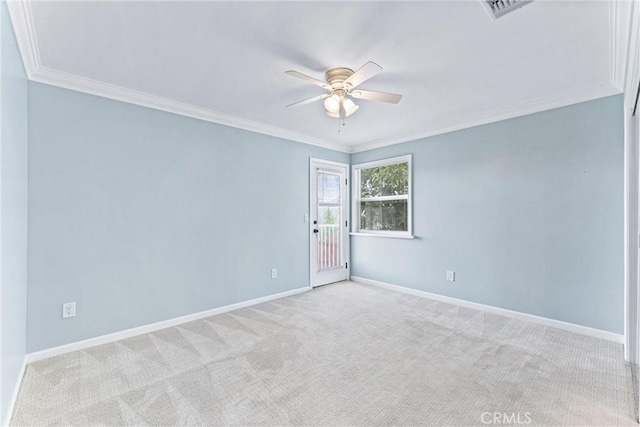 carpeted spare room featuring ceiling fan and crown molding