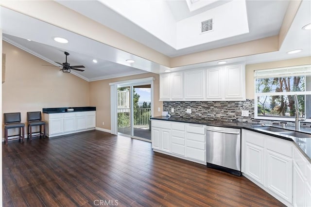 kitchen with ceiling fan, white cabinetry, stainless steel dishwasher, and sink