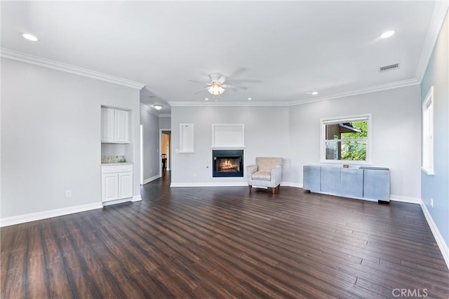 unfurnished living room featuring ceiling fan, crown molding, and dark hardwood / wood-style floors