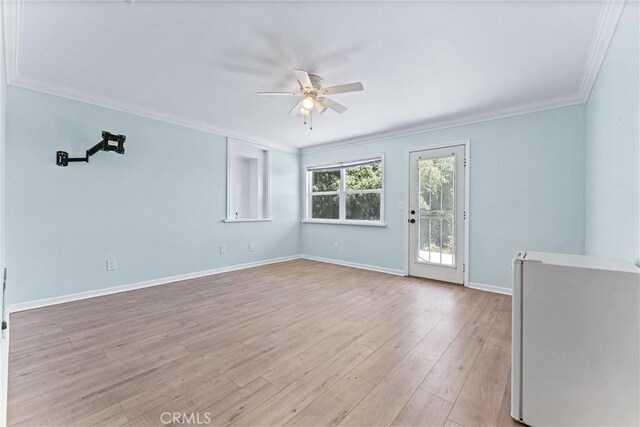 spare room with ceiling fan, ornamental molding, and light hardwood / wood-style flooring