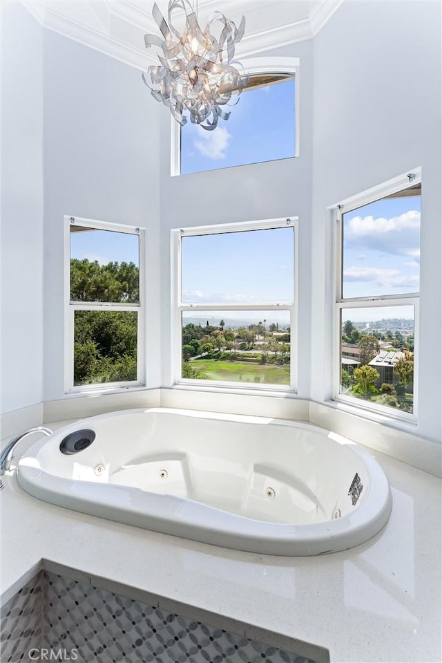 bathroom with a washtub and a notable chandelier