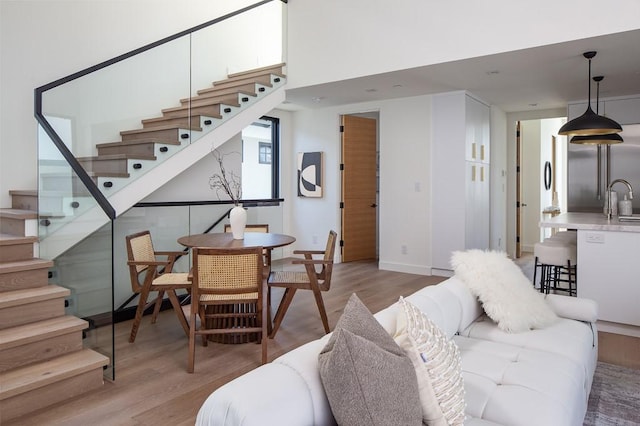 living room with sink and light hardwood / wood-style floors