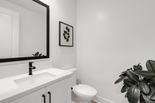 bathroom featuring toilet and vanity