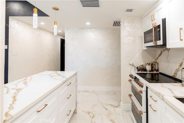 kitchen featuring light stone countertops, white cabinets, hanging light fixtures, and white appliances