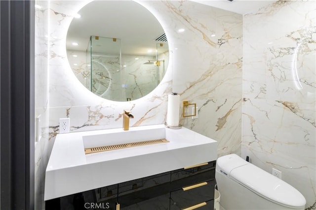 bathroom with tile walls, toilet, and vanity