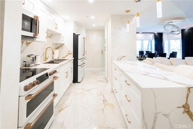 kitchen with pendant lighting, sink, white appliances, white cabinets, and light stone counters