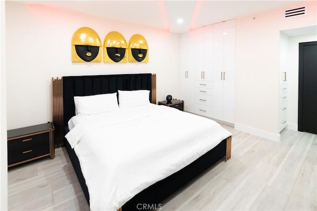 bedroom featuring light hardwood / wood-style flooring and a closet