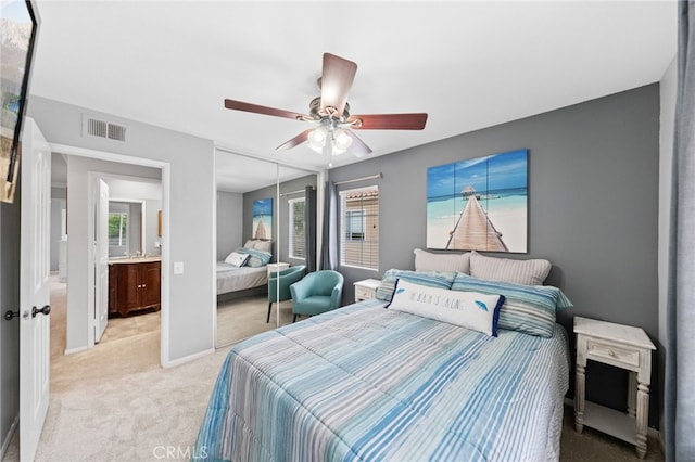 carpeted bedroom featuring ceiling fan, a closet, and multiple windows