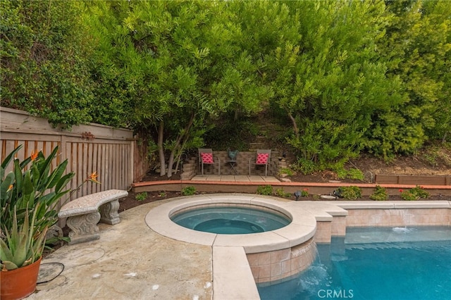 view of swimming pool with an in ground hot tub and a patio area