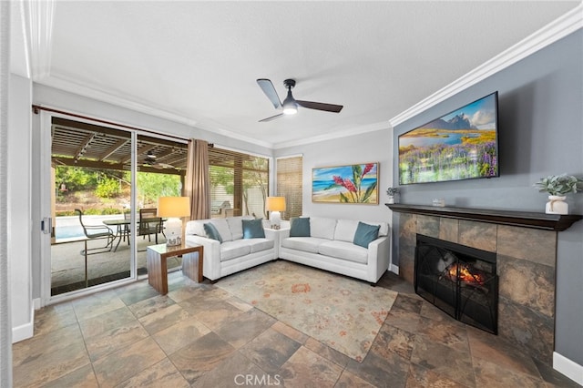 living room with ceiling fan, a fireplace, ornamental molding, and a textured ceiling