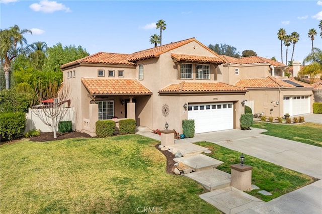 mediterranean / spanish house with a front lawn and a garage