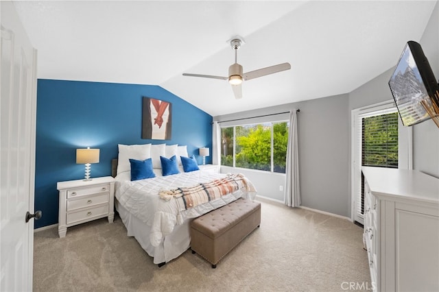 bedroom featuring ceiling fan, light carpet, multiple windows, and lofted ceiling