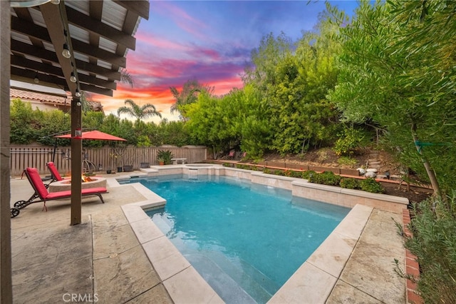 pool at dusk featuring a patio area