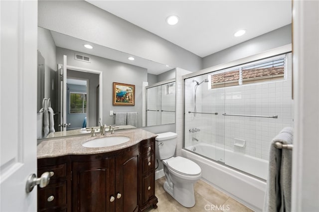 full bathroom with toilet, tile patterned flooring, enclosed tub / shower combo, and vanity