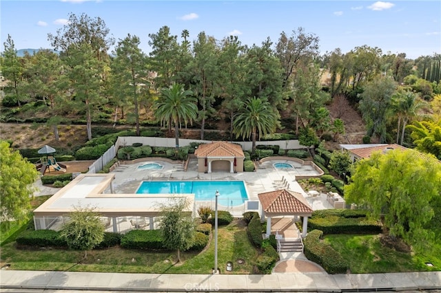 view of pool with a patio area, a gazebo, and a playground