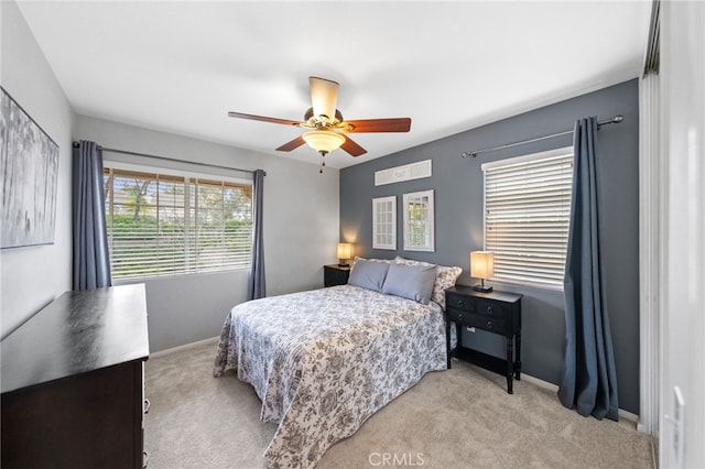 bedroom featuring ceiling fan and light carpet