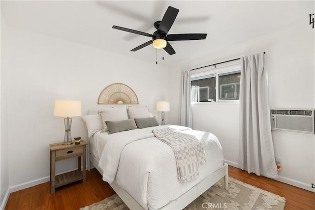 5536 Linden Ave, Long Beach, CA 90805 - bedroom with ceiling fan, baseboards, a wall mounted AC, and wood finished floors