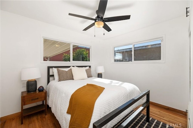 bedroom featuring ceiling fan and dark hardwood / wood-style floors