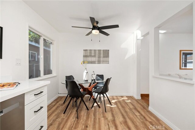 dining space featuring ceiling fan and light hardwood / wood-style flooring