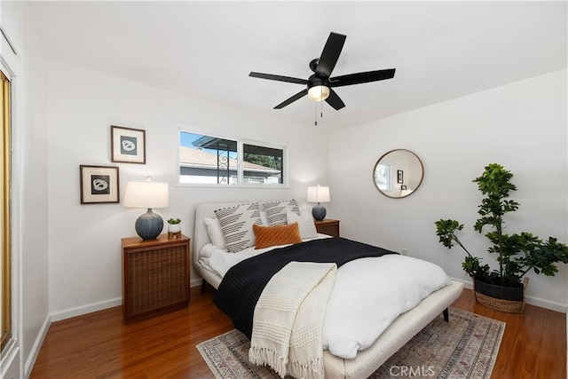 bedroom with ceiling fan and hardwood / wood-style floors