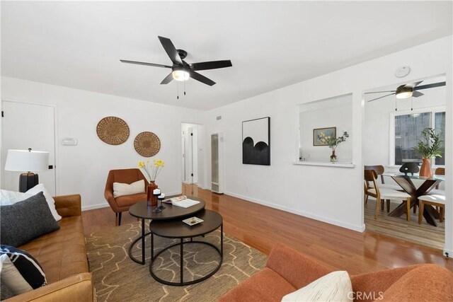 5536 Linden Ave, Long Beach, CA 90805 - living room featuring a ceiling fan, baseboards, wood finished floors, and a heating unit