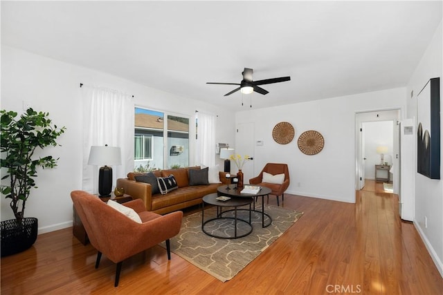 living room with ceiling fan and light wood-type flooring