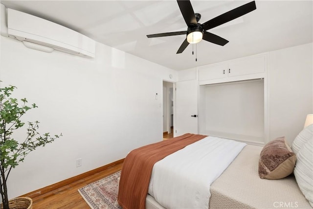 5536 Linden Ave, Long Beach, CA 90805 - bedroom with ceiling fan, baseboards, a closet, light wood finished floors, and an AC wall unit