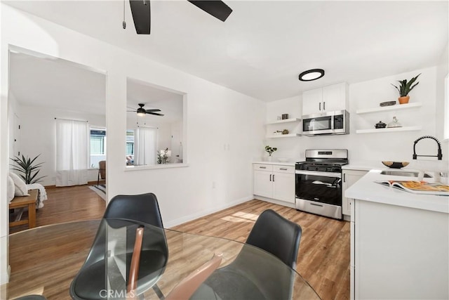 5536 Linden Ave, Long Beach, CA 90805 - kitchen featuring ceiling fan, open shelves, a sink, light countertops, and stainless steel appliances