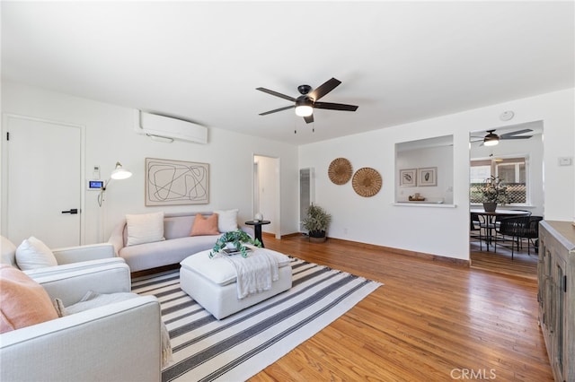 5536 Linden Ave, Long Beach, CA 90805 - living room with baseboards, a wall mounted air conditioner, light wood finished floors, and ceiling fan