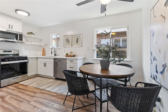5536 Linden Ave, Long Beach, CA 90805 - kitchen featuring ceiling fan, light wood-type flooring, light countertops, a sink, and appliances with stainless steel finishes