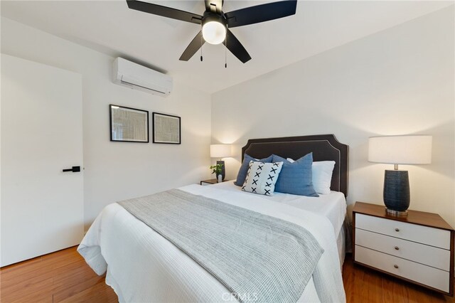 5536 Linden Ave, Long Beach, CA 90805 - bedroom featuring ceiling fan, a wall mounted air conditioner, and wood finished floors