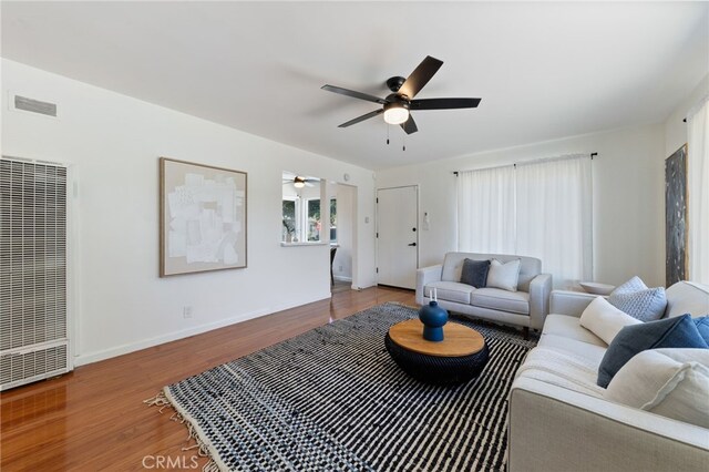 5536 Linden Ave, Long Beach, CA 90805 - living room with a ceiling fan, visible vents, wood finished floors, baseboards, and a heating unit